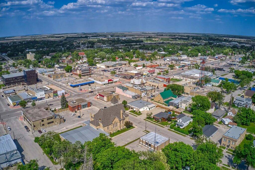 Western Manitoba 2 Aerial view of Portage la Prairie in Manitoba with residential neighborhoods and green fields.