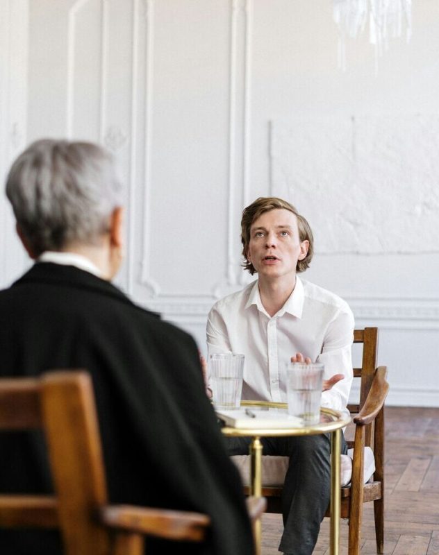 Therapist listening to young man